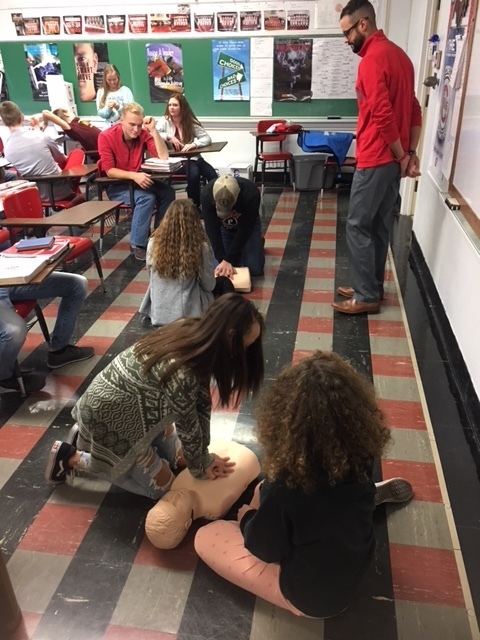 Students practicing on the CPR model.